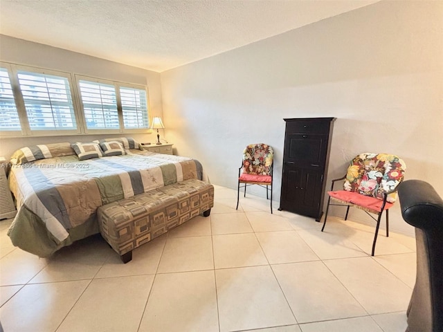 bedroom with light tile patterned floors and a textured ceiling