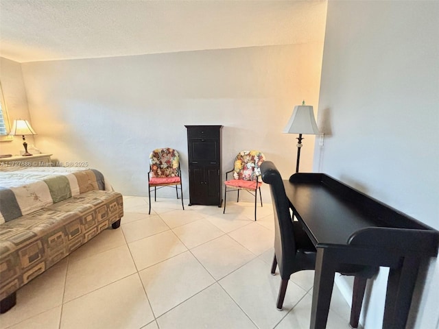 living room with a textured ceiling and light tile patterned flooring