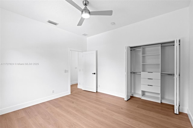 unfurnished bedroom featuring ceiling fan, light hardwood / wood-style floors, and a closet