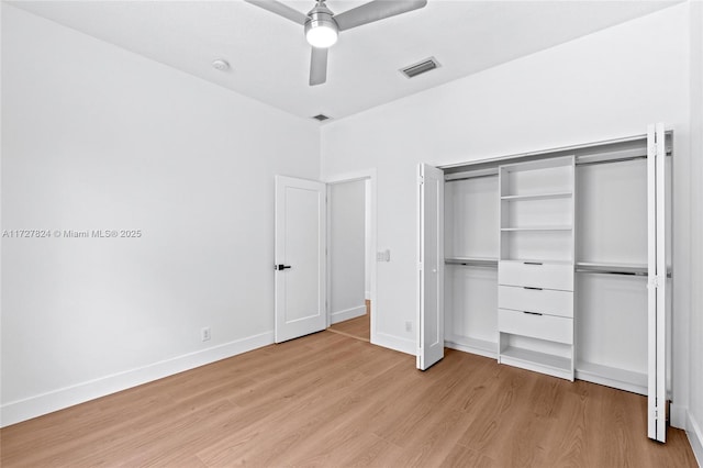 unfurnished bedroom with ceiling fan, light hardwood / wood-style flooring, and a closet