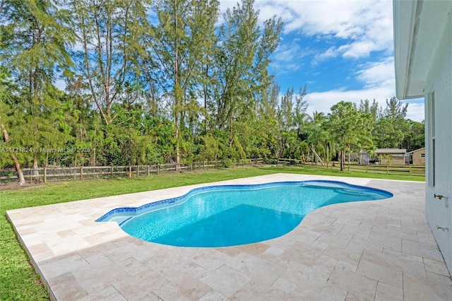 view of swimming pool with a patio area and a lawn