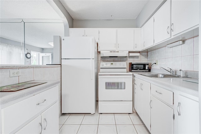 kitchen with white cabinetry, sink, tasteful backsplash, and white appliances