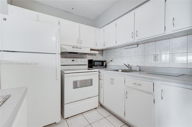 kitchen with decorative backsplash, sink, white cabinets, and white appliances