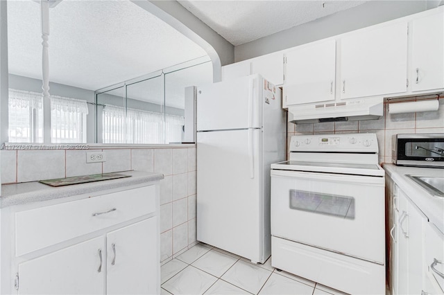 kitchen featuring white appliances, white cabinets, a textured ceiling, sink, and light tile patterned floors