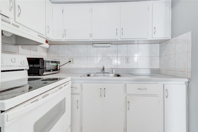 kitchen with decorative backsplash, white cabinets, white range with electric cooktop, and sink