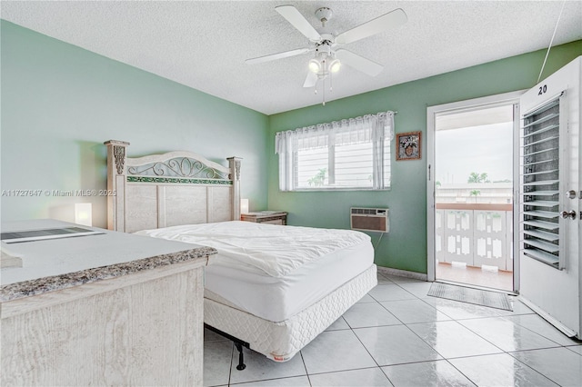 bedroom with a textured ceiling, ceiling fan, light tile patterned flooring, and an AC wall unit