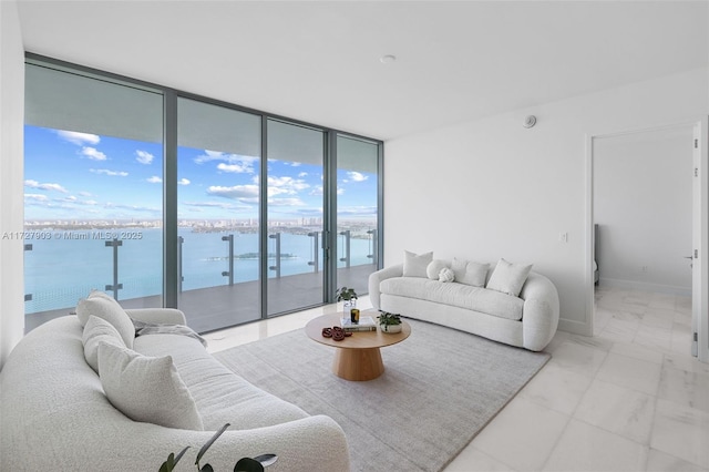 living room featuring expansive windows and a water view