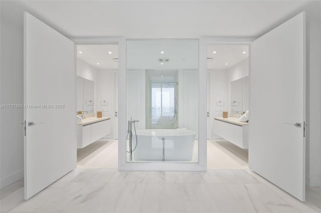 bathroom featuring a bath and vanity