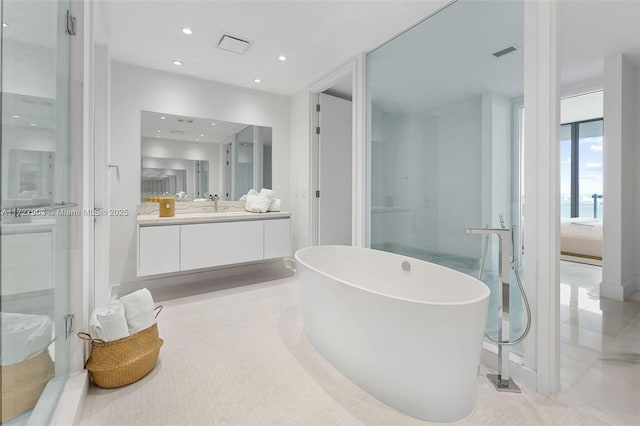 bathroom with vanity and separate shower and tub