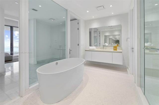 bathroom with vanity, tile patterned floors, and plus walk in shower