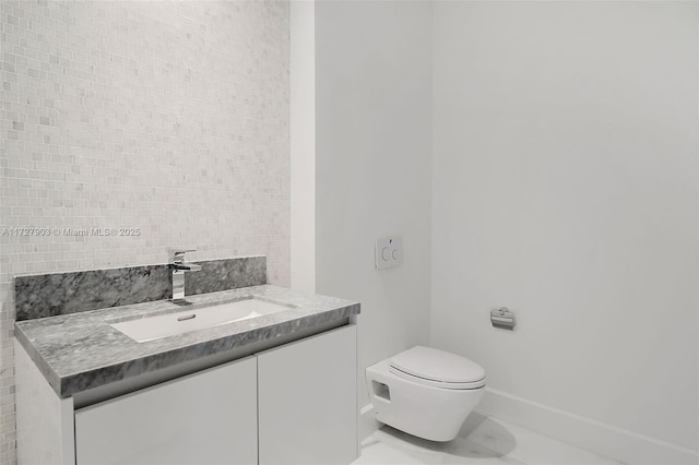 bathroom with toilet, vanity, and tile patterned floors