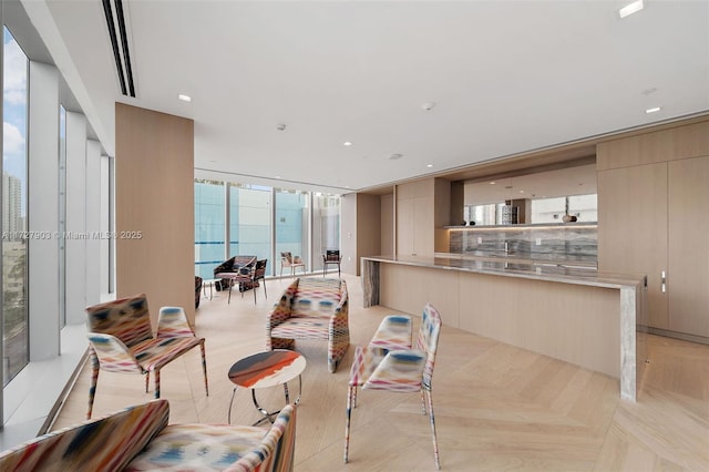 living room featuring floor to ceiling windows and light parquet flooring