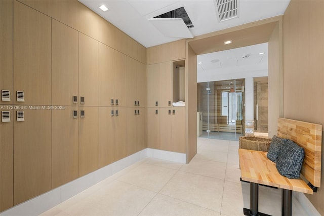 corridor featuring light tile patterned flooring