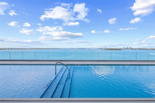 view of pool with a water view