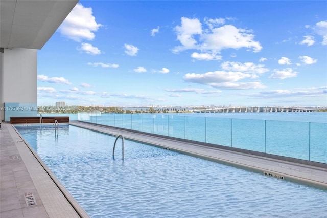 view of pool featuring a water view