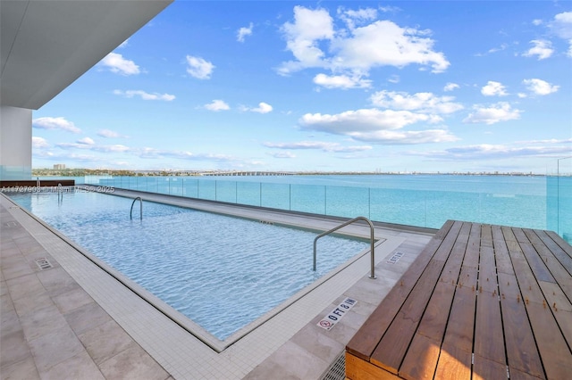 view of swimming pool with a water view