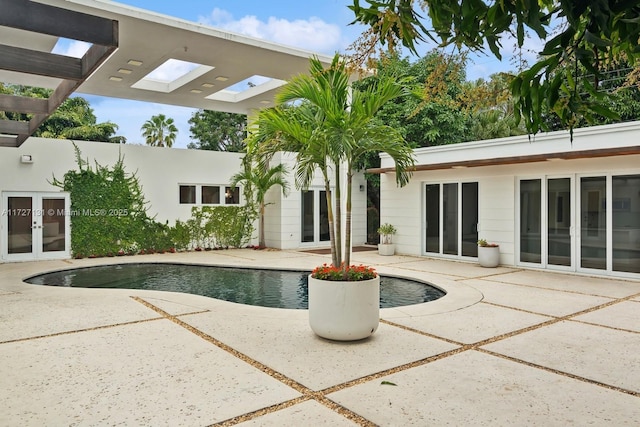 outdoor pool featuring french doors, a pergola, and a patio