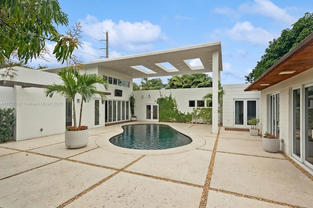 view of swimming pool featuring french doors, a patio, and a pergola