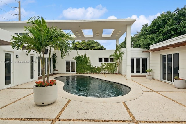 view of pool with a patio, central air condition unit, and french doors