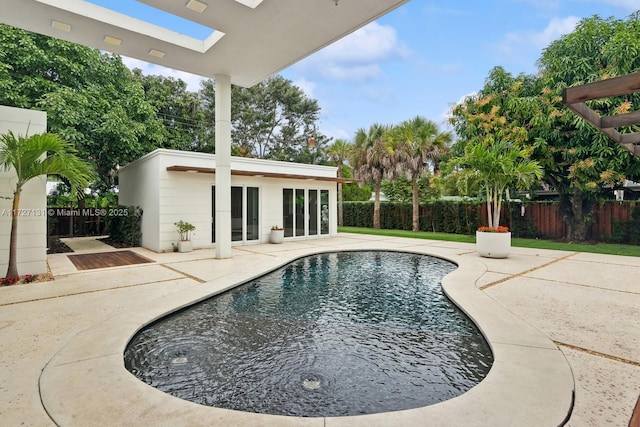 view of pool with a fenced in pool, an exterior structure, an outdoor structure, fence private yard, and a patio area