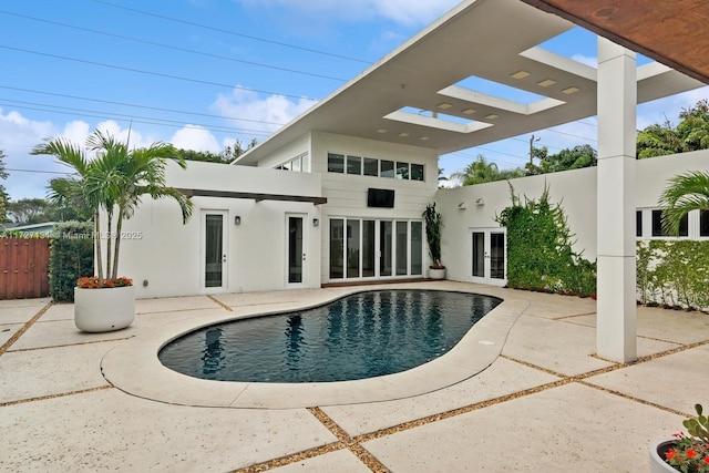 view of pool featuring a patio area, a fenced in pool, french doors, and fence