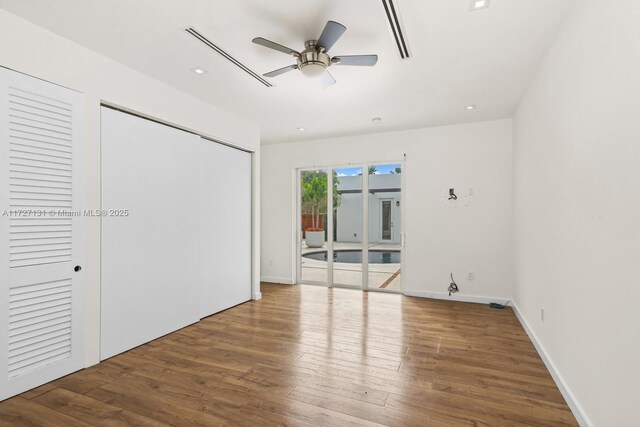 unfurnished bedroom with ceiling fan, baseboards, recessed lighting, wood finished floors, and access to outside
