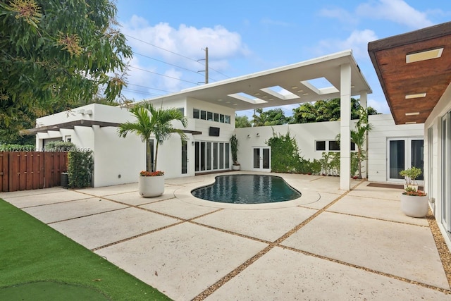 view of swimming pool with a pergola, fence, french doors, a fenced in pool, and a patio area
