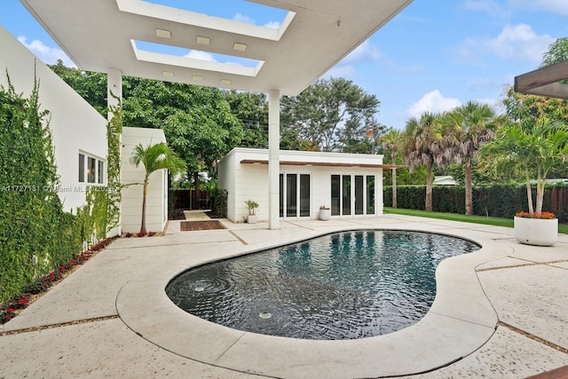 view of pool with a patio area, a fenced in pool, an outbuilding, and a fenced backyard