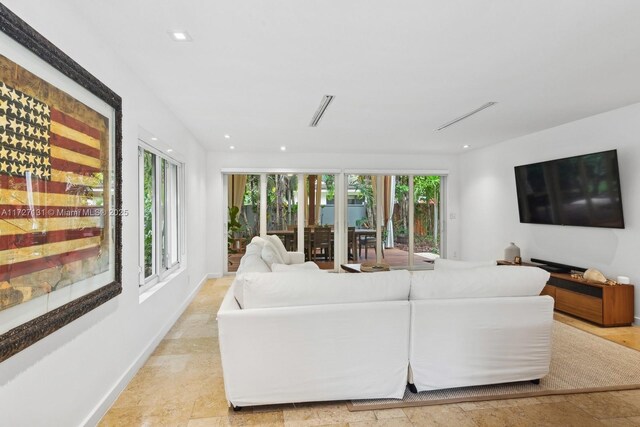 unfurnished living room featuring light hardwood / wood-style floors, french doors, and a high ceiling