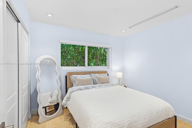 bedroom with a closet and baseboards
