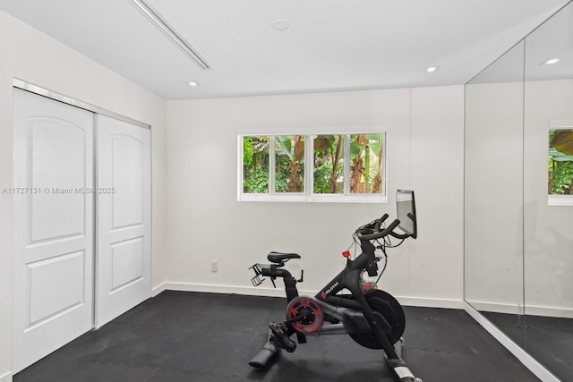workout area featuring recessed lighting and baseboards