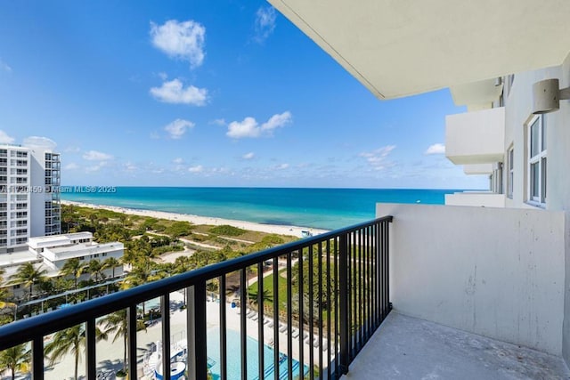 balcony with a water view and a beach view