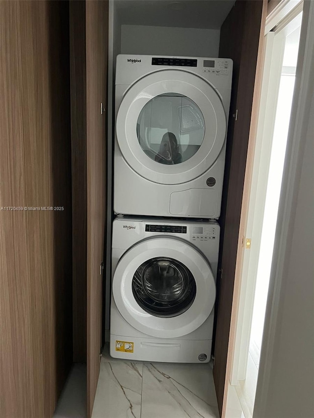 laundry area with stacked washer and clothes dryer