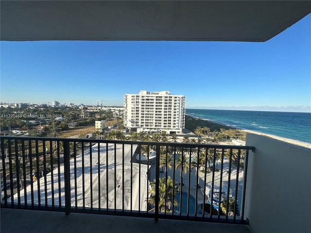 balcony featuring a water view and a beach view