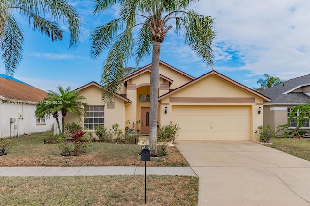 view of front of property with a front yard and a garage