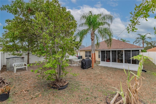 rear view of property featuring a sunroom