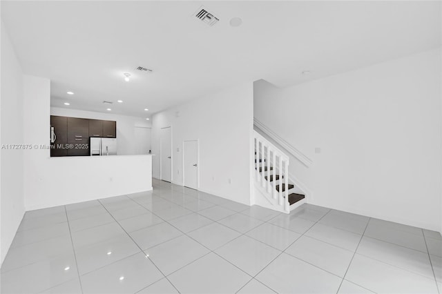 unfurnished living room featuring light tile patterned floors