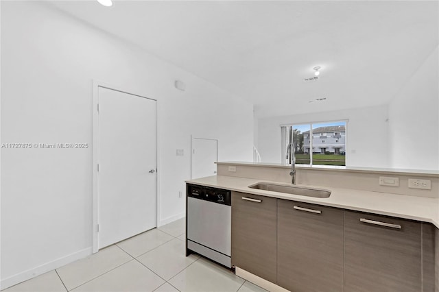 kitchen featuring light tile patterned flooring, stainless steel dishwasher, dark brown cabinetry, and sink