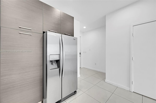 kitchen featuring stainless steel fridge with ice dispenser and light tile patterned floors