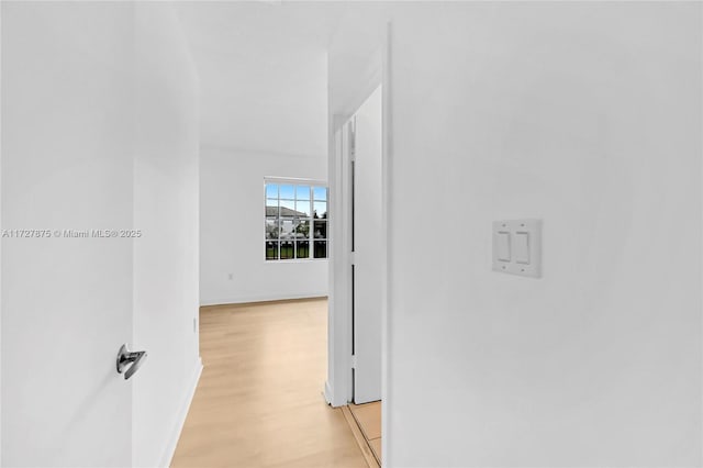 corridor with light wood-type flooring