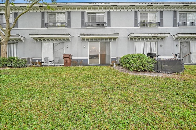 back of house with a lawn