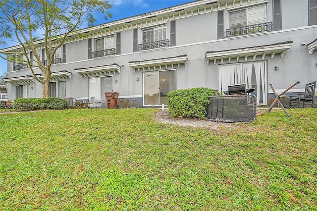 rear view of property with a yard