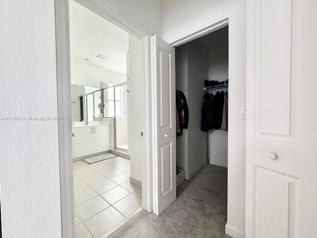 hallway featuring light tile patterned floors