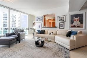 tiled living room with floor to ceiling windows