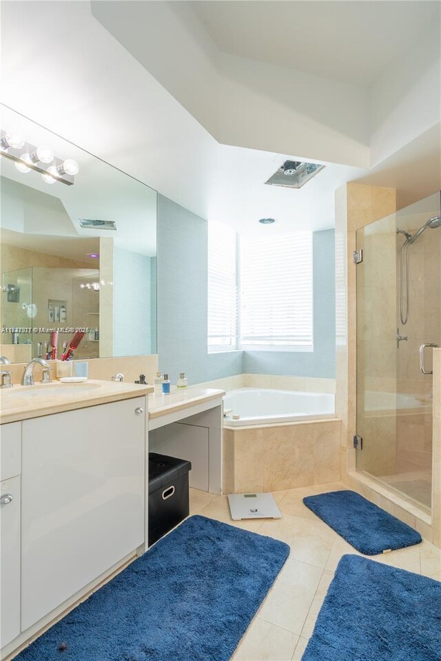 bathroom with independent shower and bath, tile patterned flooring, and vanity