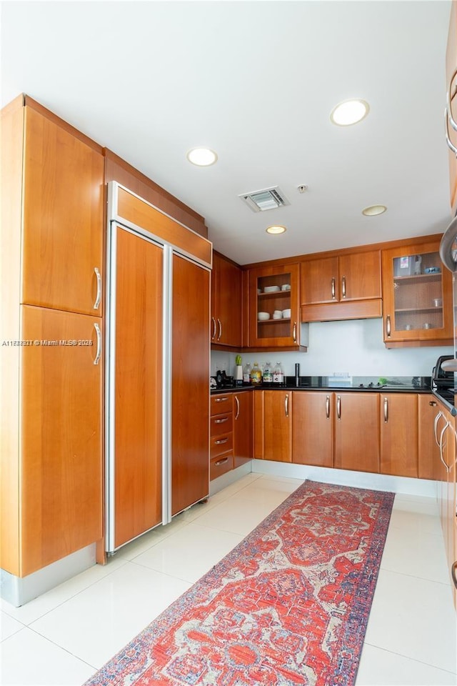 kitchen with light tile patterned flooring and paneled fridge