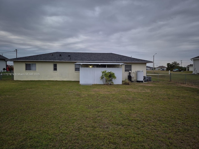 rear view of property with a yard