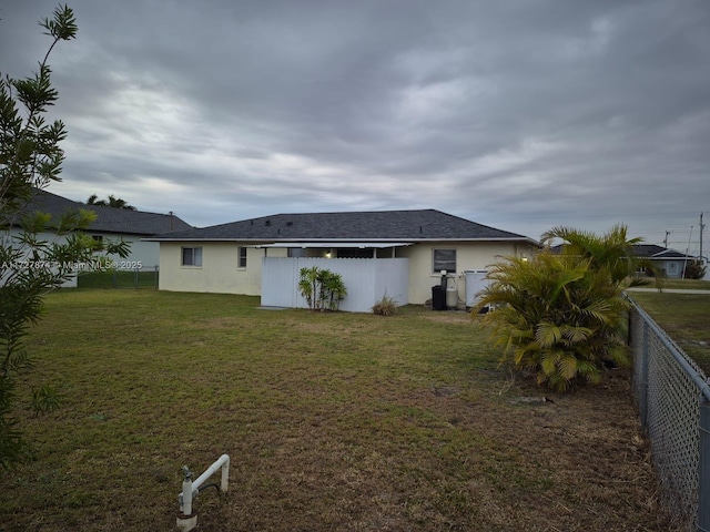 rear view of property with a yard