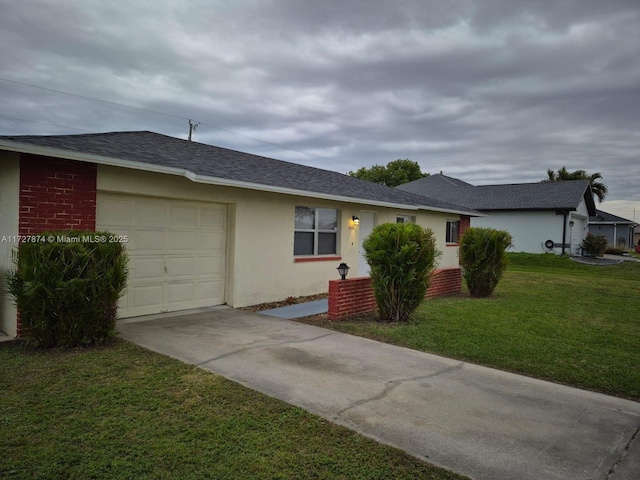 single story home featuring a garage and a front lawn