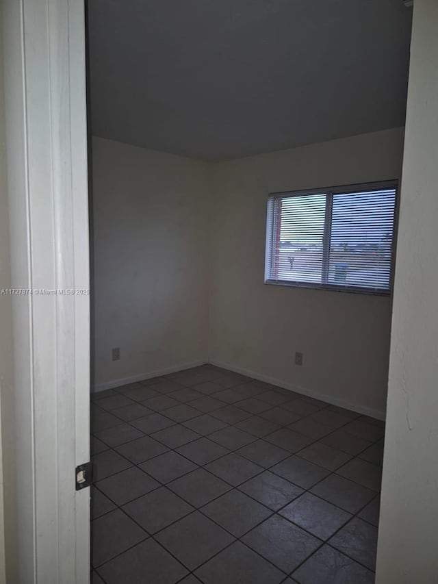 spare room with tile patterned floors